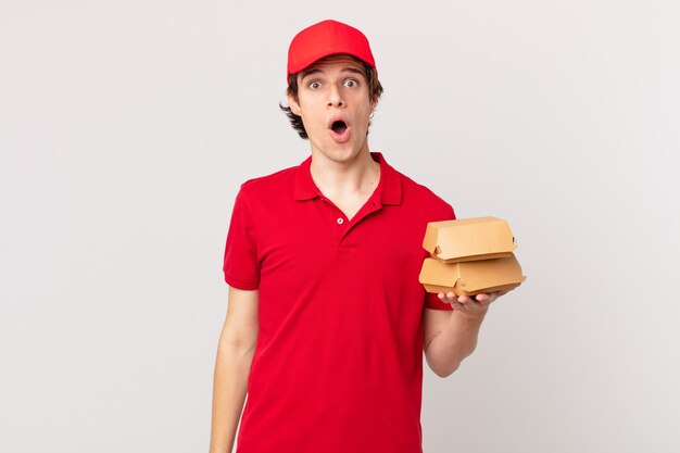 Burger deliver man looking very shocked or surprised