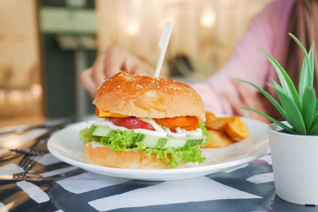 Burger and french fries on a cafe table