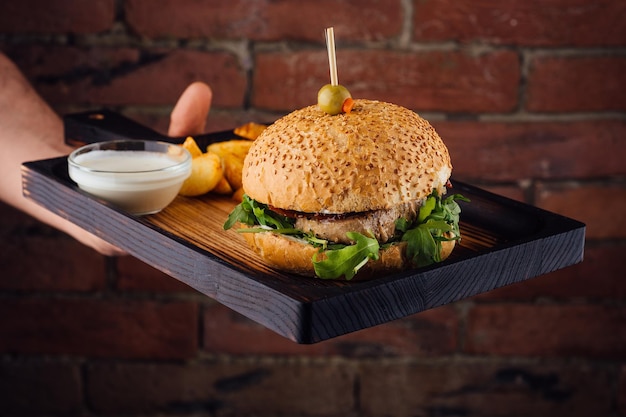 Burger and french fries in hands