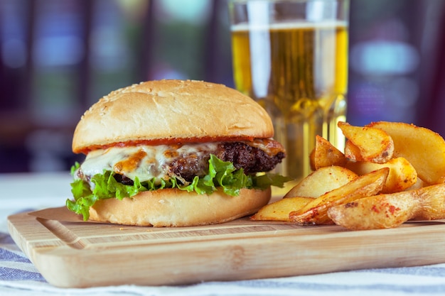 Burger and french fries on wooden table