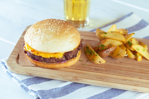 Burger and french fries on wooden table