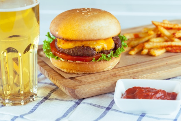 Burger and french fries on wooden table