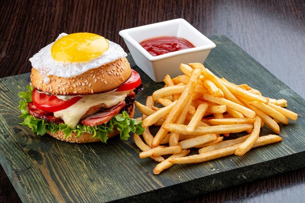 Burger for kids with fries and sauce On a wooden background