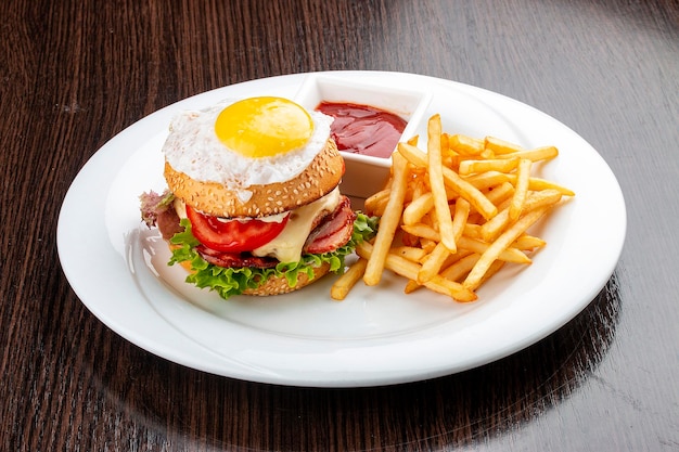 Burger for kids with fries and sauce On a wooden background