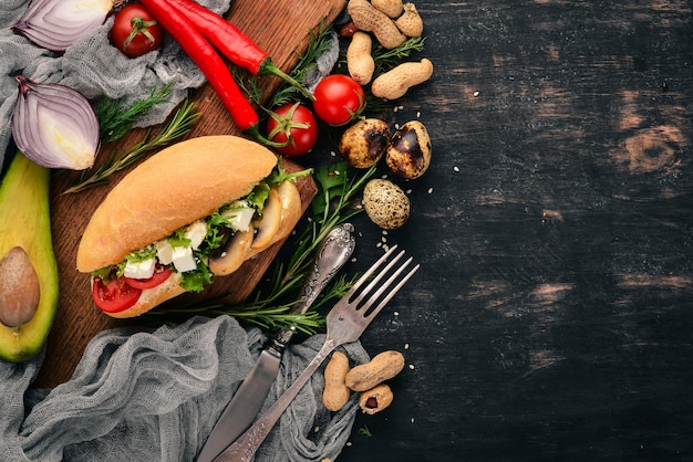 Burger sandwich with feta cheese mushrooms and lettuce leaves On a wooden background Top view Copy space