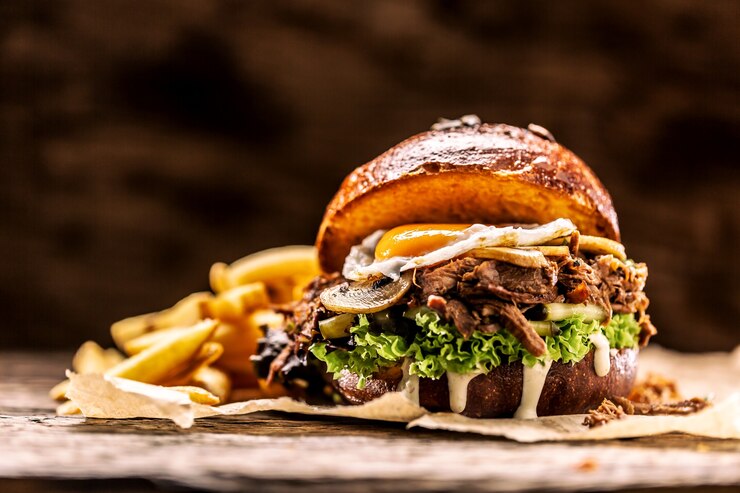 Photo burger stuffed with shredded confit turkey egg mushrooms and french fries.