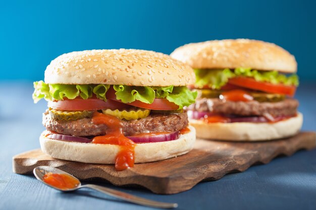 Burger with beef patty lettuce onion tomato ketchup