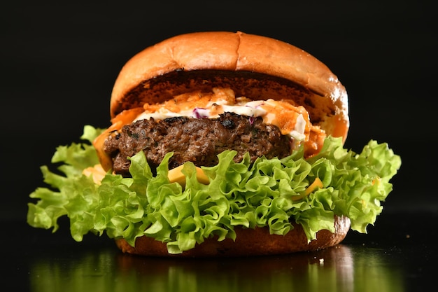 A burger with a bun and lettuce on it