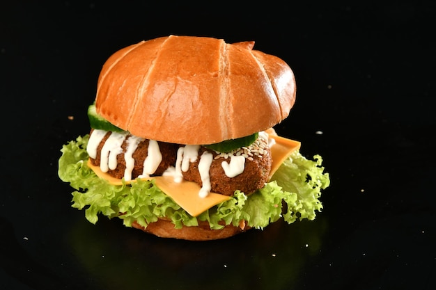 A burger with a bun and mayonnaise on it