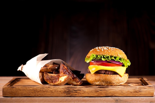 Burger with cutlet and fried potatoes