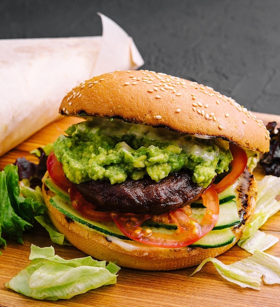 Burger with french fries on wooden tray