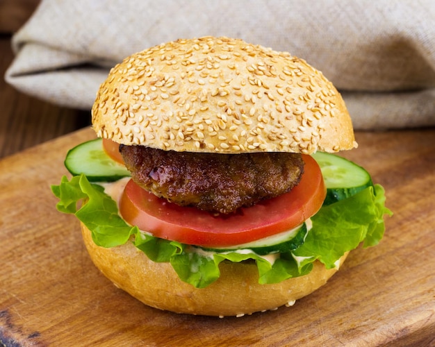 Burger with fresh lettuce and tomatoes and cucumbers