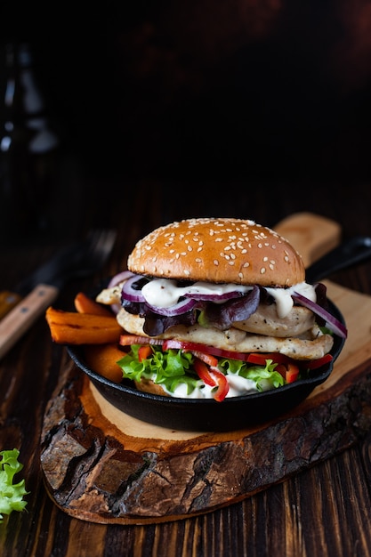 burger with grilled chicken fillet, paprika, sweet potato, lettuce, onions, and Greek yogurt