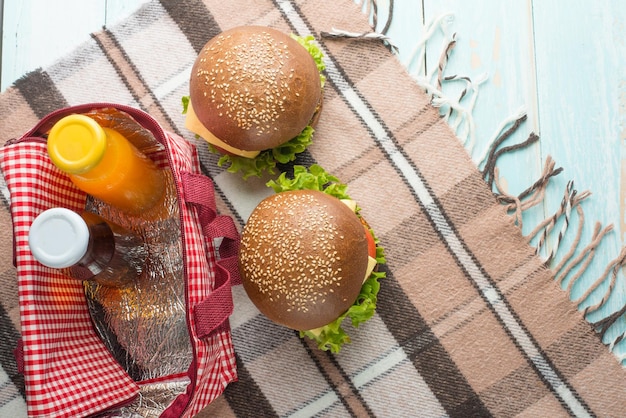 Photo burger with juice and picnic bag top view with empty space for inscription