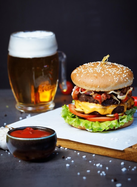 a burger with ketchup and a pint of beer on the table