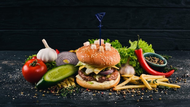 Burger with lard veal cheese and lettuce American Traditional Food On a black wooden background Copy space