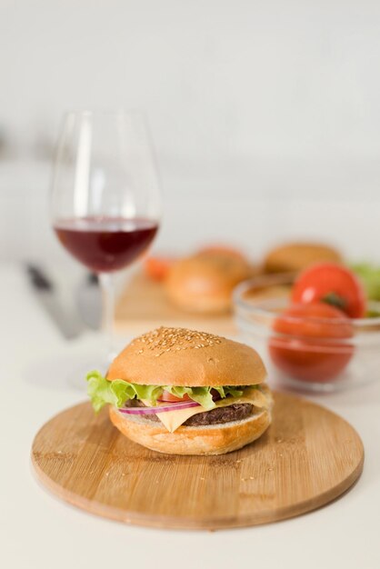 Burger on wooden board and wine