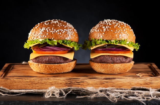 Burgers cheeseburgers on rustic board