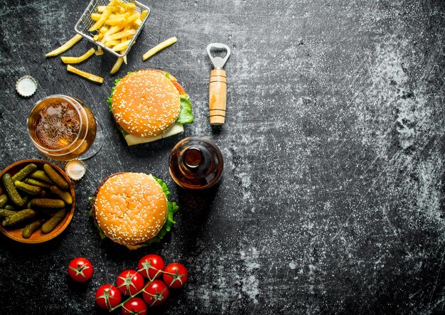 Burgers with beer in a glass and a bottle