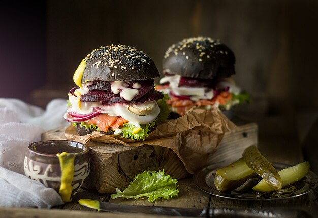 Burgers with salmon on a wooden board