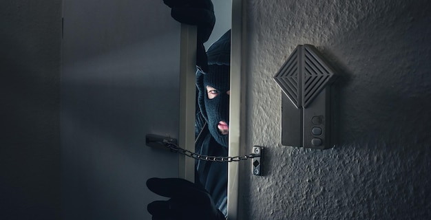 Burglar Breaking Into the House door at night