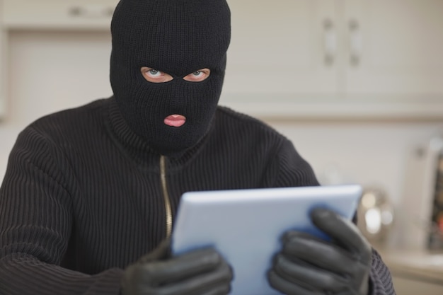 Burglar stealing the tablet pc