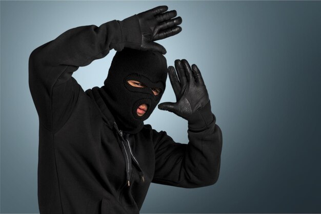 Burglar wearing black mask and gloves