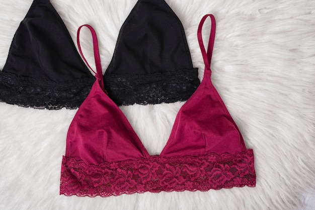 Burgundy and black bra on a wooden background. 