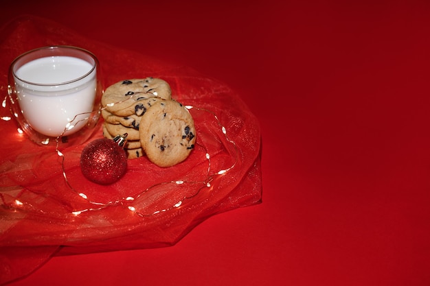 Burgundy Christmas background with biscuits and milk