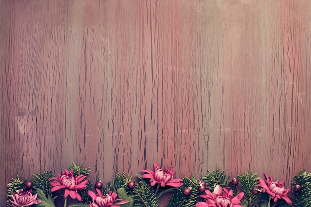 Burgundy chrysanthemum flowers on  tabled table with winter decorations, copy space