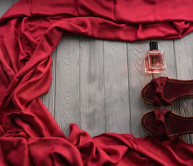 burgundy sandals wedge shawl shoes and bottle pink perfume.