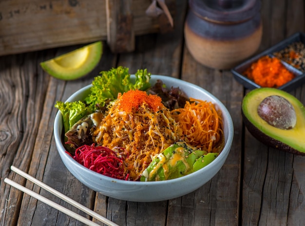 Buri salad served in a dish isolated on wooden background side view of salad