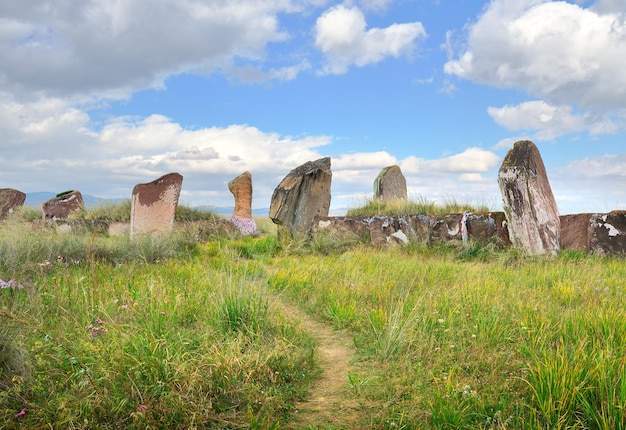 The burial mound of the 5th century BC steles of red stone under a blue sky Siberia Russia