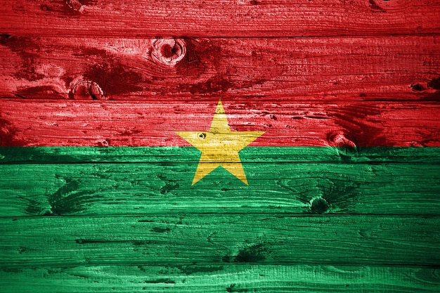 Burkina Faso flag on wooden planks background wood flag