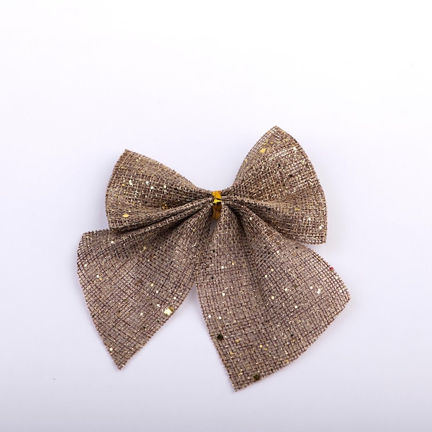 Burlap bow with gold glitter on white background Christmas holiday decor