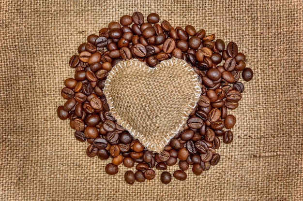 Burlap heart on pile of coffee beans