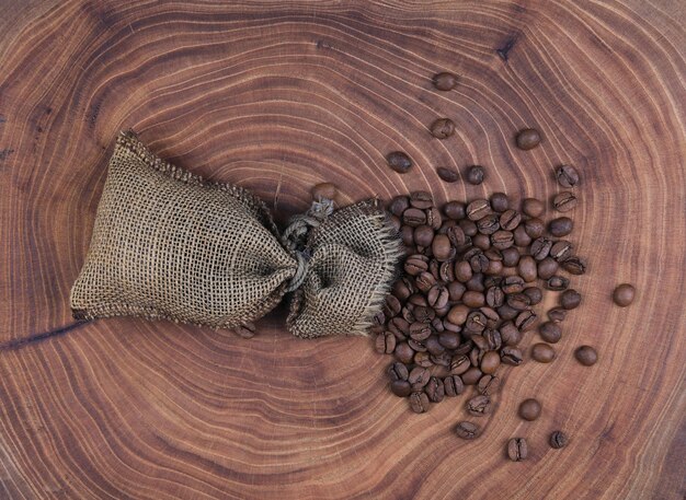 burlap sack and coffee beans on an old wooden table