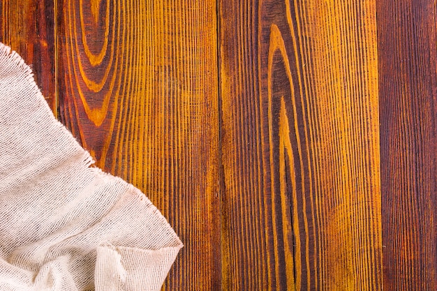 Burlap texture on wooden table background.