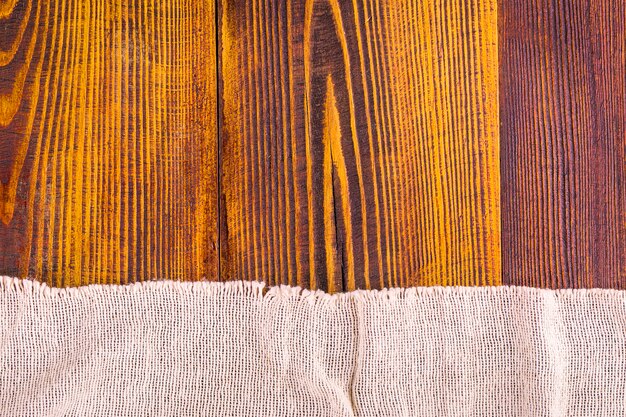 Burlap texture on wooden table background.