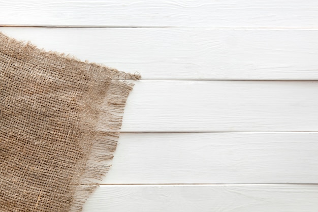 Burlap on white wooden background