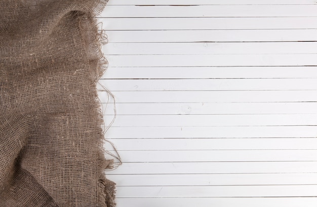 Burlap on white wooden 