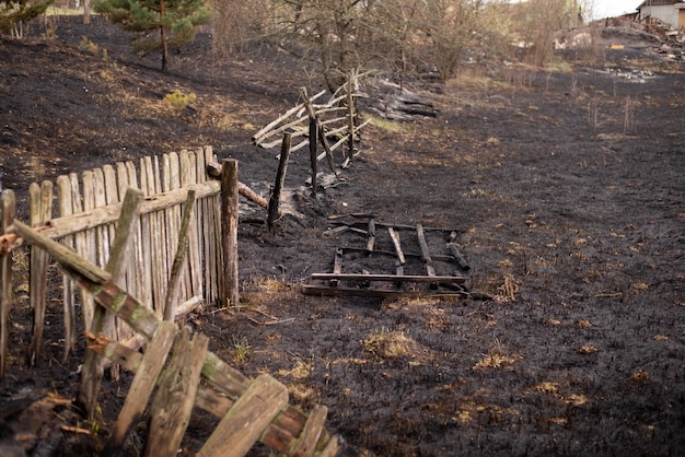 Burned grass and fence of the private property in the countryside