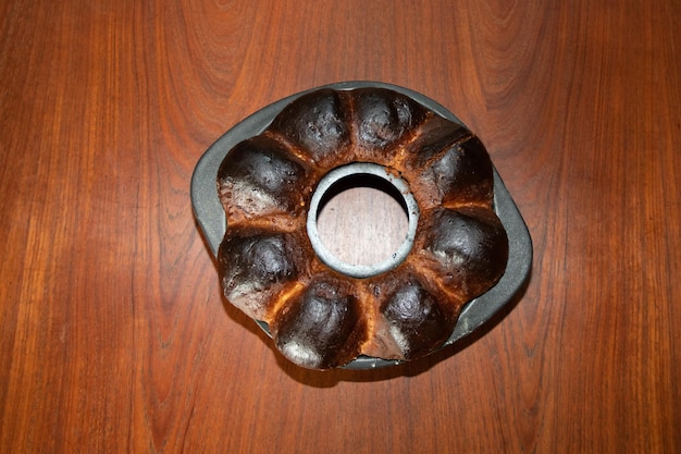 Burned homemade brioche cake burnt in the oven black failed baking on charcoal