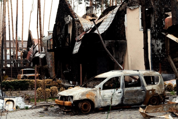 Burned house from a rocket attack Russian invasion of Ukraine Russia's war against Ukraine destroyed multistorey building in ukraine big fire in the house burnt car