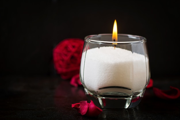 Burning candle on a black background