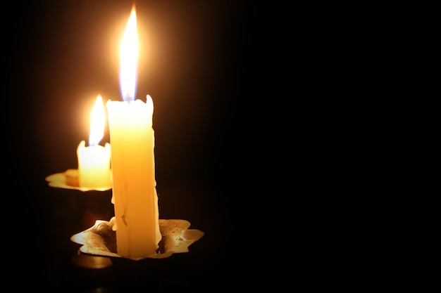 Burning candle on a black background