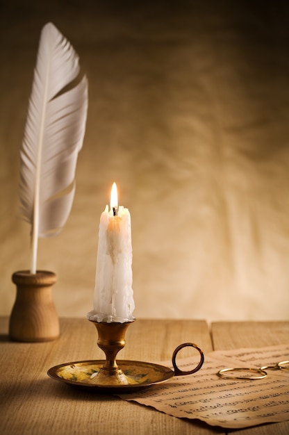 Burning candle in vintage candlestick