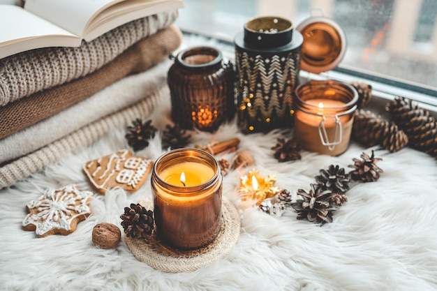 Burning candle on windowsill in cozy home interior