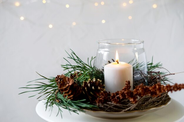 Burning candles on the Christmas table.         