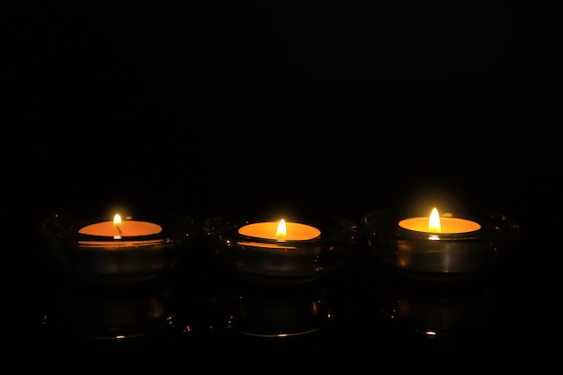 Burning candles on dark background